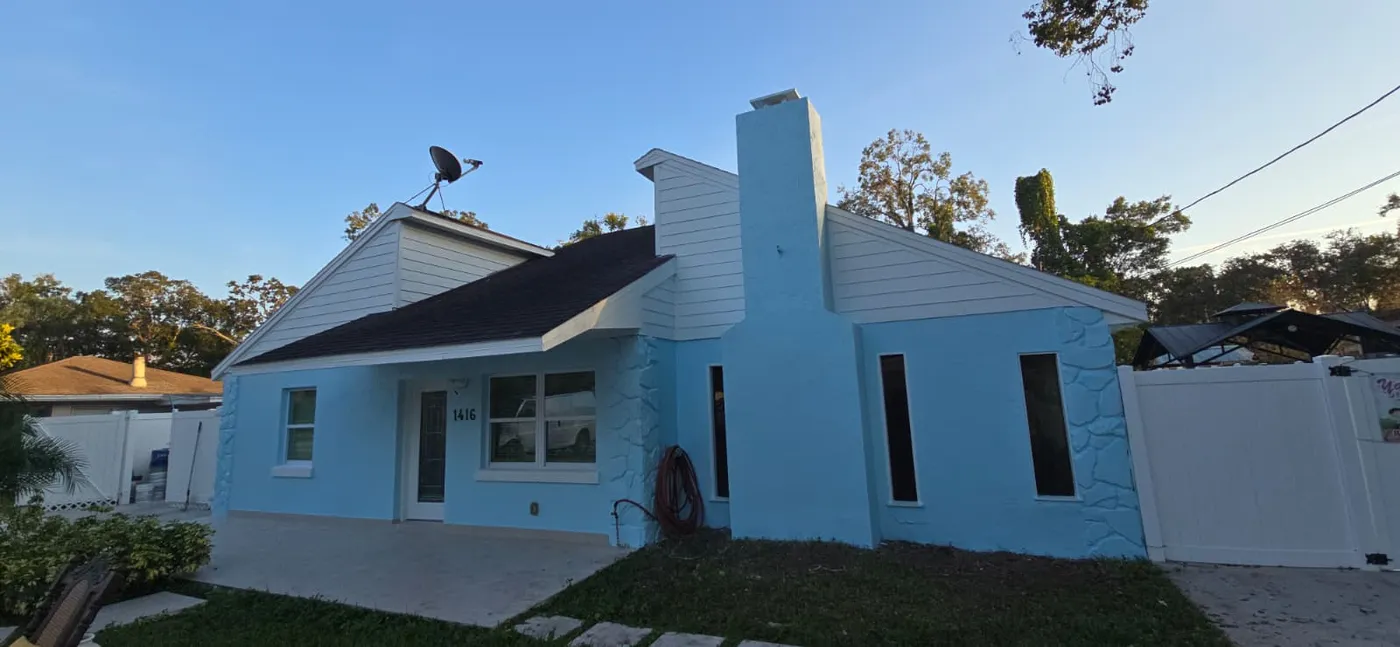Same stucco home repainted a light blue color