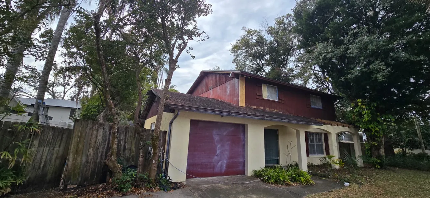 Home exterior with faded wood siding before repainting