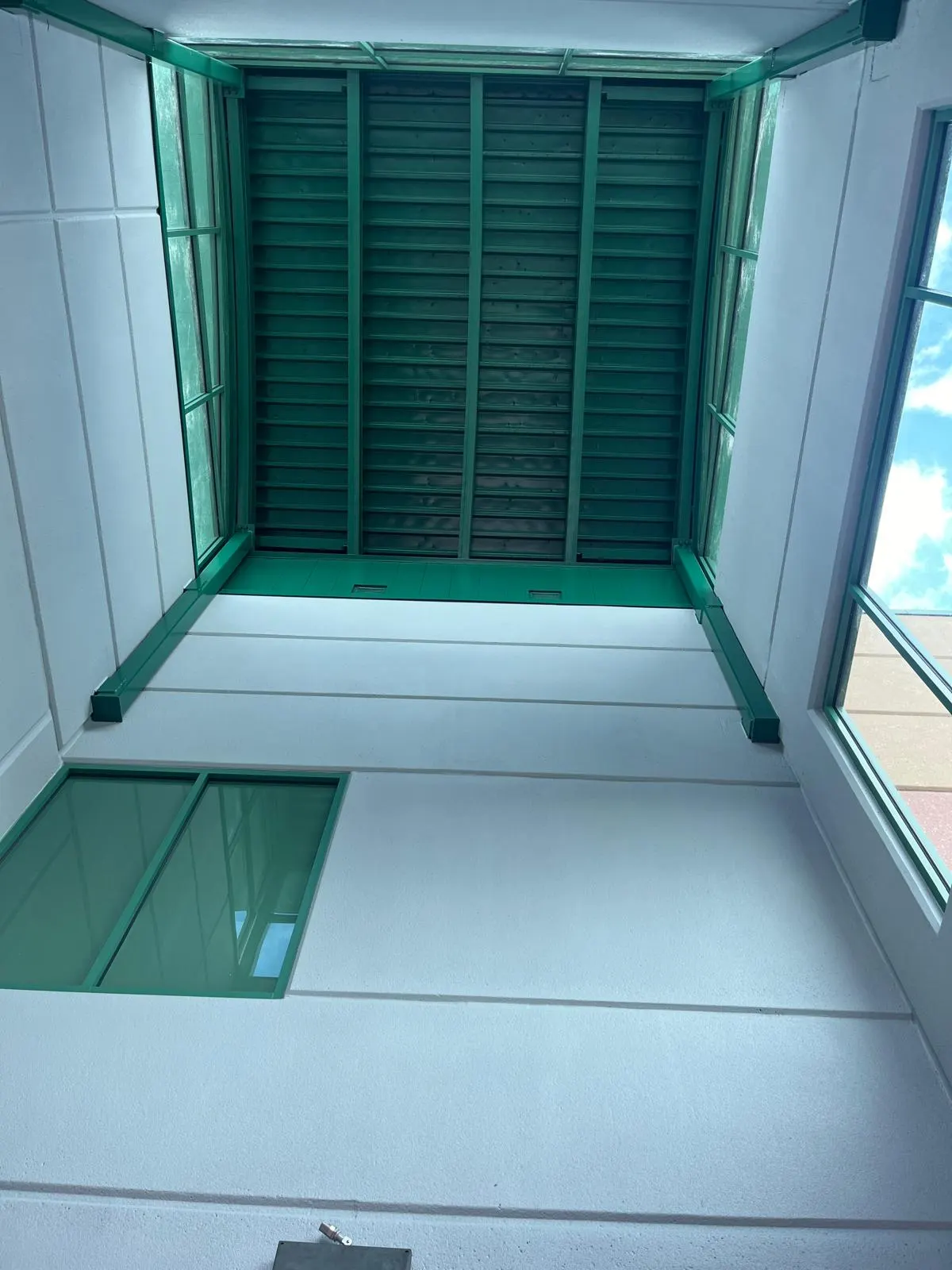 Painted ceiling and louvers above a stadium concession booth