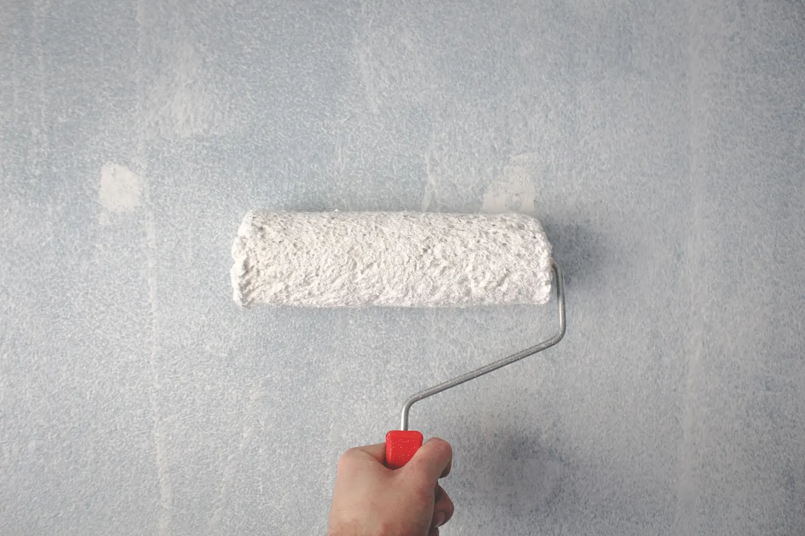 Interior wall being painted with a roller